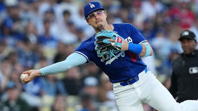 Mar 23, 2025; Los Angeles, California, USA; Los Angeles Dodgers third baseman Kike Hernandez (8) throws the ball to first base against the Los Angeles Angels at Dodger Stadium. Mandatory Credit: Kirby Lee-Imagn Images