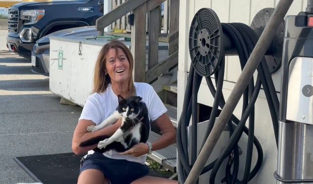 Luigi the cat and his owner after he was located at the BC Ferries Tsawwassen terminal on Sunday, Aug. 25, 2025.