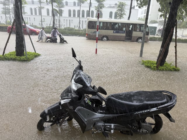 Streets of the capital city, Hanoi, are flooded due to heavy rain after Typhoon Kajiki passed through Vietnam, Tuesday, Aug. 26, 2025. (AP Photo/Hau Dinh)