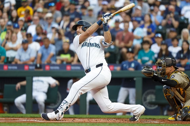 Aug 25, 2025; Seattle, Washington, USA; Seattle Mariners catcher Cal Raleigh (29) hits a solo-home run against the San Diego Padres during the first inning at T-Mobile Park. The home run is the 50th of the season for Raleigh. Mandatory Credit: Joe Nicholson-Imagn Images