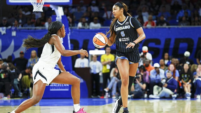 Aug 25, 2025; Chicago, Illinois, USA; Chicago Sky forward Angel Reese (5) brings the ball up court against Las Vegas Aces guard Jackie Young (0) during the first half at Wintrust Arena. Mandatory Credit: Kamil Krzaczynski-Imagn Images