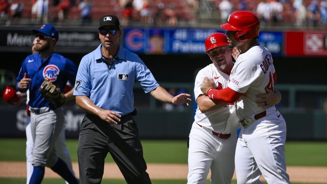 Jun 26, 2025; St. Louis, Missouri, USA; St. Louis Cardinals first baseman Willson Contreras (40) is held back by first base coach Stubby Clapp (82) as he exchanges words with Chicago Cubs relief pitcher Daniel Palencia (not pictured) after the Cubs defeated the Cardinals at Busch Stadium. Mandatory Credit: Jeff Curry-Imagn Images