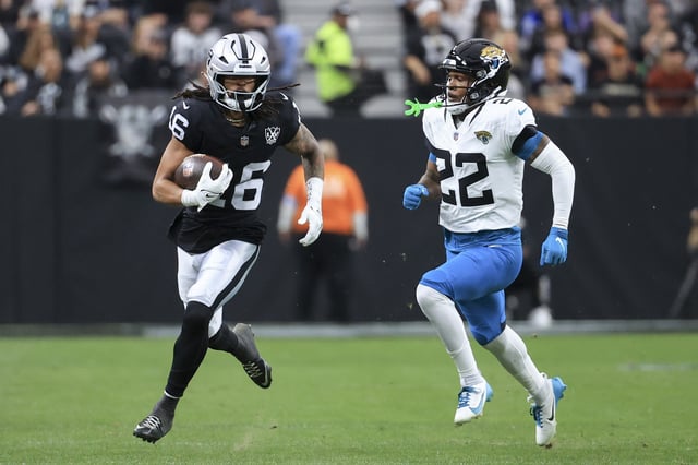 LAS VEGAS, NEVADA - DECEMBER 22: Jakobi Meyers #16 of the Las Vegas Raiders runs past Jarrian Jones #22 of the Jacksonville Jaguars after a catch in the second quarter of a game at Allegiant Stadium on December 22, 2024 in Las Vegas, Nevada. (Photo by Ian Maule/Getty Images)