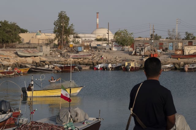 Two fishermen are sailing along a beach near the Bushehr nuclear power plant in a coastal village on the northern coast of the Persian Gulf in Bushehr province, 1090km (677 miles) south of Tehran, Iran, on April 29, 2024. The Bushehr nuclear power plant, Iran's first and only active nuclear power plant, was fully operationalized and connected to the national electricity grid in 2011 after a long history of construction delays and political challenges. (Photo by Morteza Nikoubazl/NurPhoto via AP)
