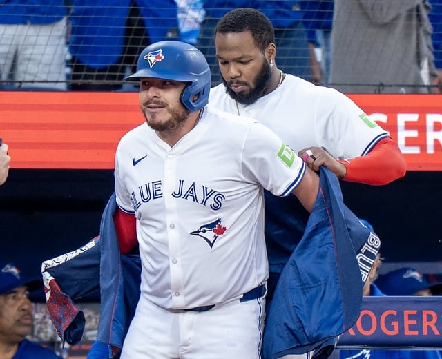 Blue Jays designated hitter Vladimir Guerrero Jr. (back) puts the home run jacket on catcher Alejandro Kirk after his two-run homer in the first inning of a Major League Baseball game against the Minnesota Twins in Toronto on Monday, Aug. 25, 2025. THE CANADIAN PRESS/Frank Gunn
