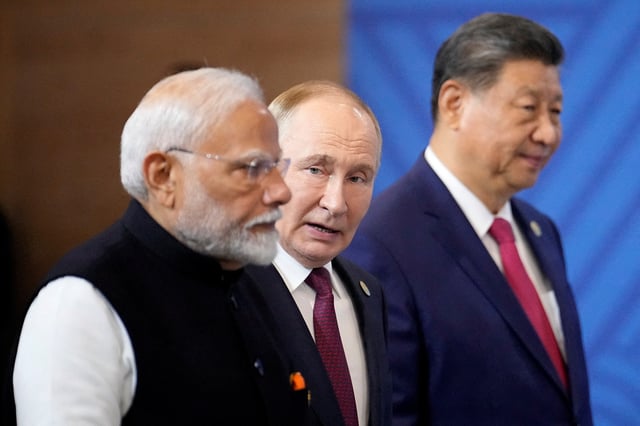 Indian Prime Minister Narendra Modi, Russian President Vladimir Putin and Chinese President Xi Jinping attend a family photo ceremony prior to the BRICS Summit plenary session in Kazan, Russia, Wednesday, Oct. 23, 2024.     Alexander Zemlianichenko/Pool via REUTERS/File Photo