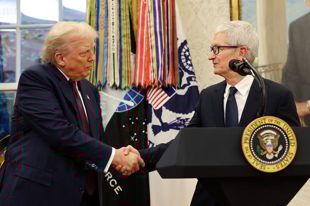 Apple CEO Tim Cook (R) shakes hands with U.S. President Donald Trump during an event in the Oval Office of the White House on August 6, 2025 in Washington, DC.