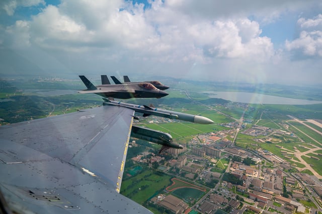 Two United States F-35A fighter jets fly alongside an F-16 fighter jet during a dogfighting training scenario as part of Exercise Ulchi Freedom Shield 25 at Kunsan Air Base in South Korea on August 20, 2025.