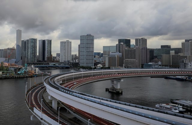 A view of the Tokyo skyline is seen through the window of a bus in Tokyo, Japan, August 2, 2021. REUTERS/Amr Abdallah Dalsh/File Photo