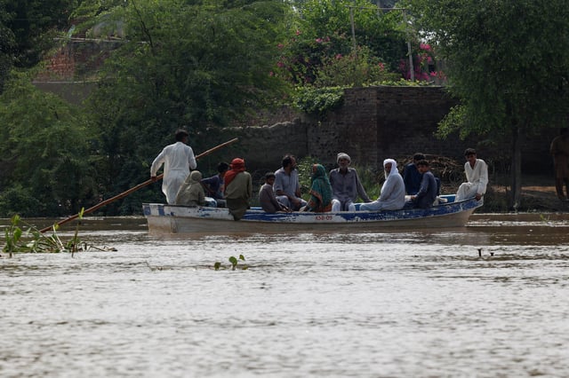 Residents use a boat to reach their destination in flooded areas due to the monsoon rains and rising water level of the Sutlej River, in Hakuwala village near the Pakistan-India border in Kasur district of the Punjab province, Pakistan August 23, 2025. REUTERS/Akhtar Soomro/File Photo