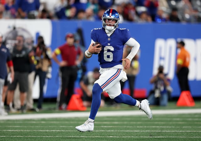 Jaxson Dart #6 of the New York Giants runs with the ball against the New England Patriots during their NFL Preseason game at MetLife Stadium on August 21, 2025 in East Rutherford, New Jersey.