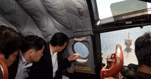 Members of Japan's ruling Liberal Democratic Party inspect a Chinese structure constructed in the East China Sea from a Japanese P-3C patrol aircraft on June 29, 2025.