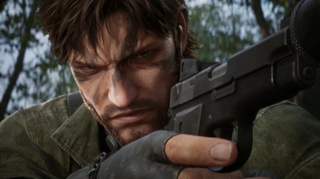 Metal Gear Solid Delta: Snake Eater launch times release date - A close-up shot of Snake aiming with his pistol, squinting his eyes and scrunching his face.