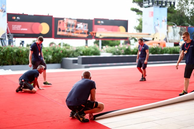 Workers set up the red carpet a day before the start of the 82nd Venice Film Festival in Venice, Italy, August 26, 2025. REUTERS/Yara Nardi