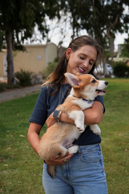 Doron Steinbrecher, a released hostage, who was held by Hamas in Gaza for 471 days, holds her dog, following an interview with Reuters, in Kibbutz Shefayim, Israel, August 25, 2025.  REUTERS/Miro Maman