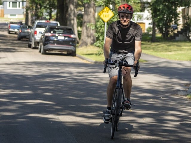 Karl Tracksdorf rides his bike after listening to Transportation Minister Devin Dreeshen as he meets with members of Edmonton’s Delton and Alberta Avenue community to talk about bike lane projects in their neighbourhoods on Monday, Aug. 25, 2025, in Edmonton.