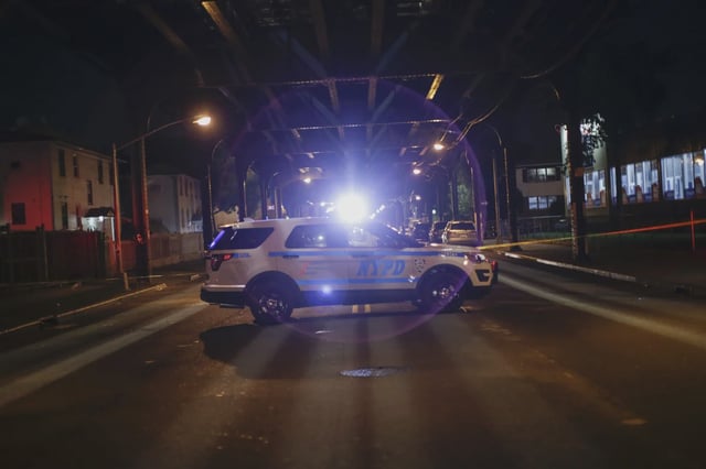 A NYPD car at a crime scene in Ozone Park.