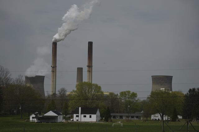 FILE - A home sits near the Gen. James Gavin Power Plant, a coal-fired power plant, April 14, 2025, in Point Pleasant, W.Va. (AP Photo/Joshua A. Bickel, File)