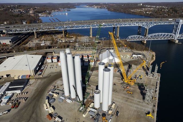 Crews assemble the tower of a wind turbine for the Revolution Wind offshore wind turbine farm on November 20, 2024. The project was halted by the Trump administration last week despite being 80% complete.