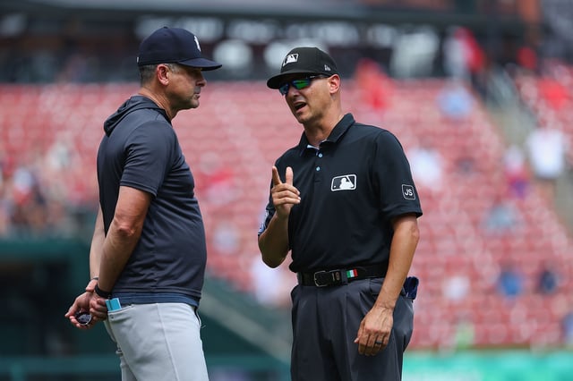 ST LOUIS, MISSOURI - AUGUST 17: Umpire Vic Carapazza #19 talks to manager Aaron Boone #17 of the New York Yankees during a game against the St. Louis Cardinals at Busch Stadium on August 17, 2025 in St Louis, Missouri.