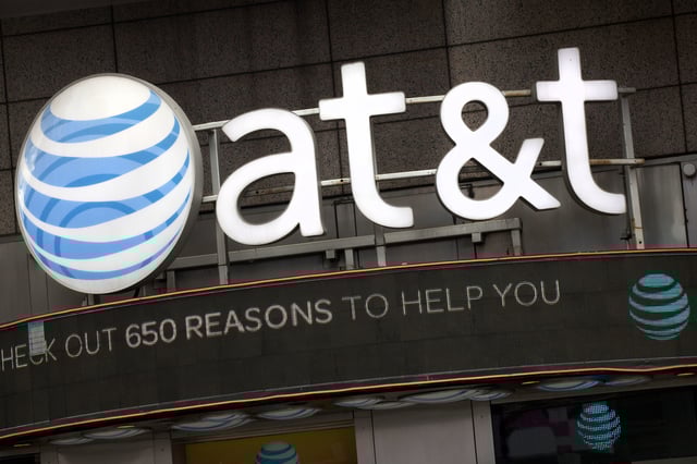 FILE - In this Oct. 24, 2016, file photo, the AT&T logo is positioned above one of its retail stores, in New York. (AP Photo/Mark Lennihan, File)