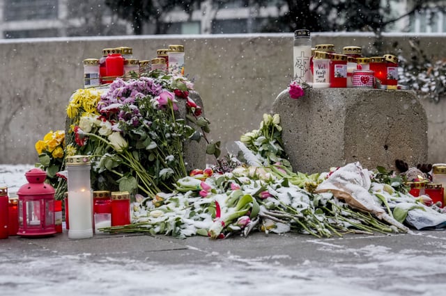 FILE - Flowers and candles are laid in Munich, Germany, Sunday, Feb. 16, 2025, near the spot where a car drove into a group of protesters three days before. (AP Photo/Matthias Schrader, File)