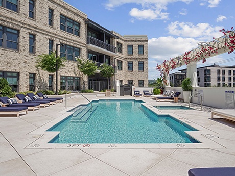 Amenities at The Society at Laurens include a heated saltwater pool and spa situated on a second-floor deck with views of Charleston Harbor.