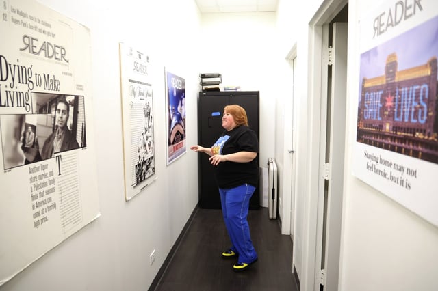 The Chicago Reader's Chief of Staff Elen Kaulig talks about the Reader's cover pages hanging on the walls at the publications office at South Michigan Avenue Aug. 25, 2025. (Antonio Perez/Chicago Tribune)