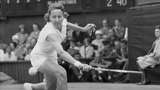 Angela Mortimer of Great Britain stretches to make a backhand on her way to victory in the 1961 Wimbledon women’s singles final against Christine Truman