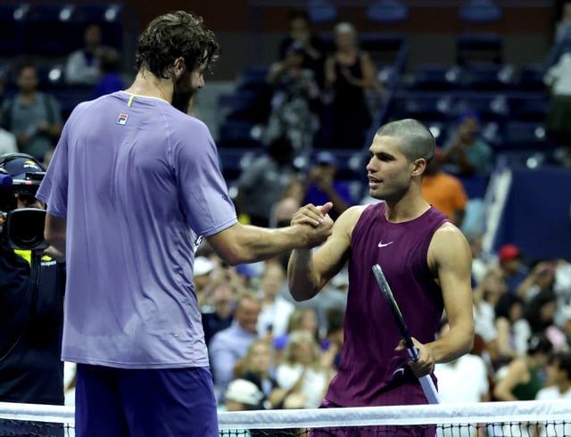 Tennis - U.S. Open - Flushing Meadows, New York, United States - August 25, 2025 Spain's Carlos Alcaraz shakes hands with Reilly Opelka of the U.S. after winning his first round match REUTERS/Jeenah Moon