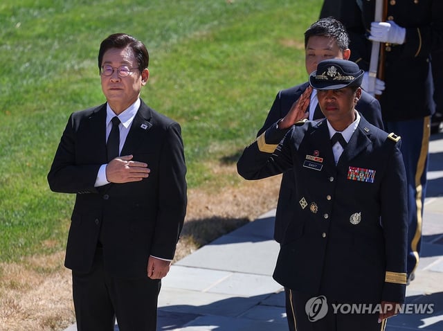 South Korean President Lee Jae Myung (L) pays respect to fallen soldiers at Arlington National Cemetery in Arlington, Virginia, on Aug. 26, 2025. (Yonhap)
