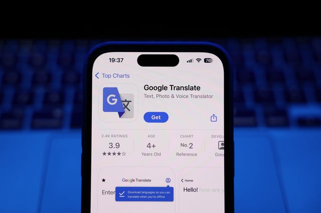 A laptop keyboard and Google Translate on App Store displayed on a phone screen are seen in this illustration photo taken in Krakow, Poland on March 17, 2025. (Photo by Jakub Porzycki/NurPhoto via Getty Images)
