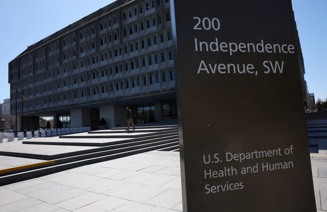 A person walks outside of the U.S. Department of Health and Human Services building after it was reported that the HHS will cut about 10,000 full-time jobs and close half of its regional offices, a major overhaul of the department under Health Secretary Robert F. Kennedy Jr., in Washington, D.C., U.S., March 27, 2025. REUTERS/Leah Millis/File Photo