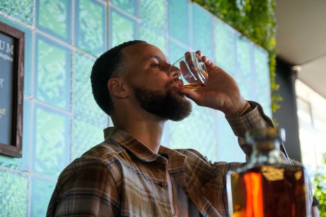Stephen Curry tastes his bourbon, Gentleman’s Cut, inside the Platinum VIP room at Bottlerock in Napa on May 25, 2024. He's opening a bourbon bar in San Francisco.