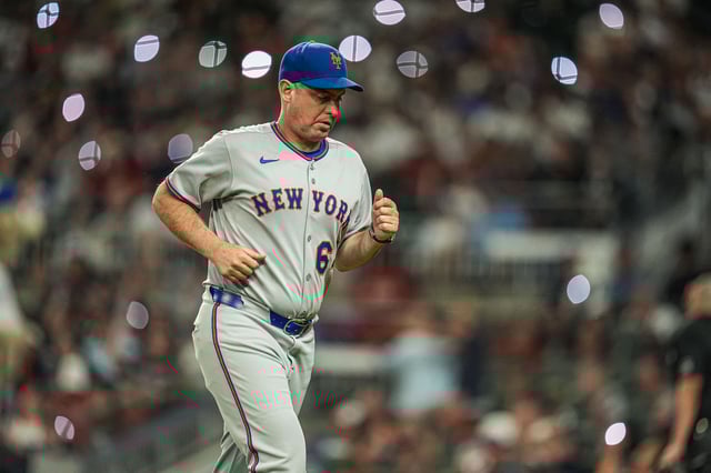 Aug 23, 2025; Cumberland, Georgia, USA; New York Mets manager Carlos Mendoza (64) on the field during the game against the Atlanta Braves during the seventh inning at Truist Park. Mandatory Credit: Dale Zanine-Imagn Images