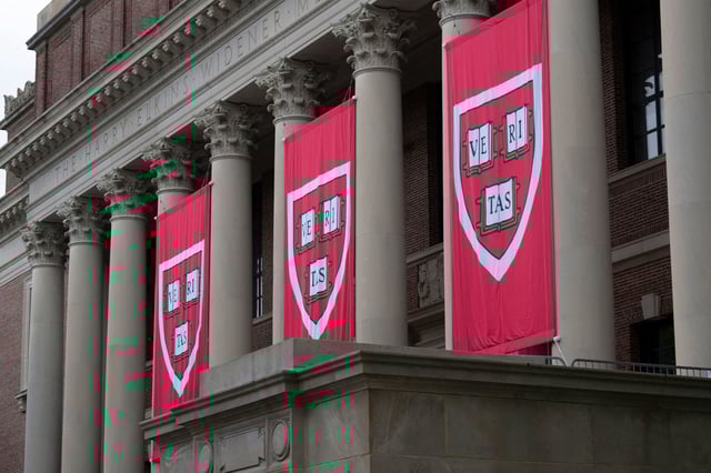Harvard banners hang in front of Widener Library during the 374th Harvard Commencement in Harvard Yard in Cambridge, Massachusetts, on May 29, 2025.