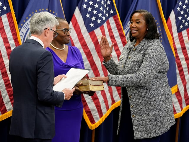 FILE - Lisa Cook, right, takes the oath of office to become a member of the Federal Reserve Board, May 23, 2022, in Washington. (AP Photo/Patrick Semansky, file)