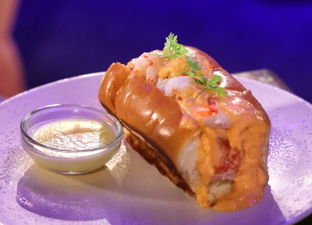 A Gulf Coast-style Seafood Roll with warm-water lobster, rock shrimp, lobster bisque, and sherry-crème fraîche on a toasted brioche bun, one of the featured dishes at the 2025 Epcot International Food & Wine Festival, Thursday, Aug. 21, 2025. The festival —featuring bites and beverages from more than 35 global marketplace kiosks— kicks off Aug. 28 and runs through Nov. 22. (Joe Burbank/Orlando Sentinel)