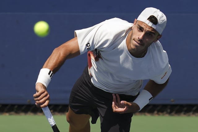 Francisco Cerundolo, of Argentina, serves to Matteo Arnold, of Italy, during the first round of the U.S. Open tennis championships, Tuesday, Aug. 26, 2025, in New York. (AP Photo/Kirsty Wigglesworth)