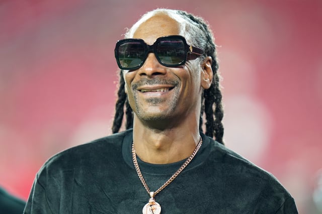 ARCHIVO - Snoop Dogg camina en la cancha antes del partido de la NFL entre los Buccaneers de Tampa Bay y los Saints de New Orleans el 19 de diciembre de 2021, en Tampa, Florida. Snoop Dogg será corresponsal de NBC para los Juegos Olímpicos de París. (Foto AP/Chris O'Meara, archivo)