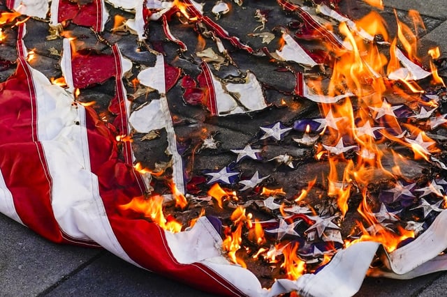 FILE - An American flag is burned during a march for Jayland Walker, July 6, 2022, in New York. (AP Photo/Frank Franklin II, File)