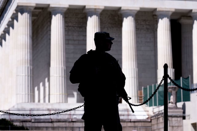 An armed member of the National Guard patrols near the Lincoln Memorial, on the National Mall in Washington, DC, on Tuesday.
