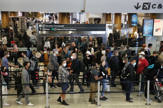 Passengers go through a security checkpoint at San Francisco International Airport in 2022. With the new Stratus coronavirus variant spreading in California, health experts advise taking precautions like masking in crowded indoor areas to avoid contracting COVID-19.