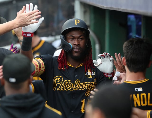 Aug 7, 2025; Pittsburgh, Pennsylvania, USA;  Pittsburgh Pirates center fielder Oneil Cruz (15) high-fives in the dugout after scoring a run against the Cincinnati Reds during the first inning at PNC Park. Mandatory Credit: Charles LeClaire-Imagn Images/File Photo