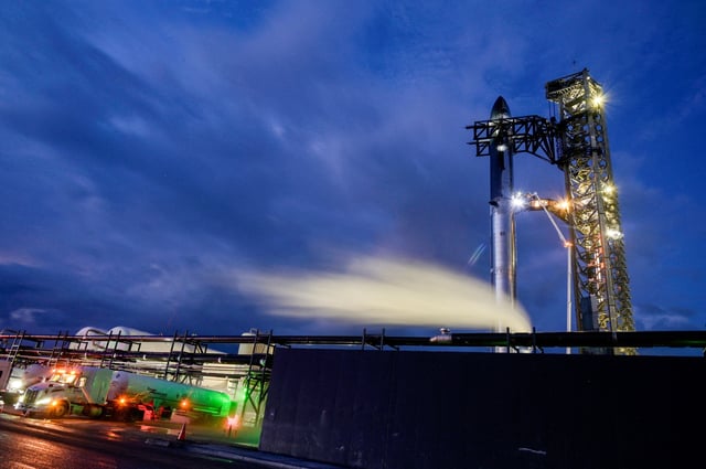 Fuel trucks carrying liquid nitrogen line up before sunrise Aug. 25 as preparations to launch a SpaceX Starship spacecraft continue at the company's Starbase complex in South Texas. Flight 10 was delayed for the second time, this time due to weather.