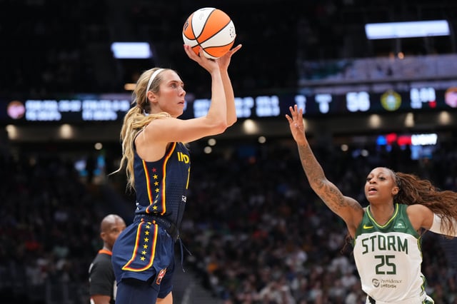 Lexie Hull #10 of the Indiana Fever shoots over Tiffany Mitchell #25 of the Seattle Storm during the second half at Climate Pledge Arena on August 03, 2025 in Seattle, Washington.