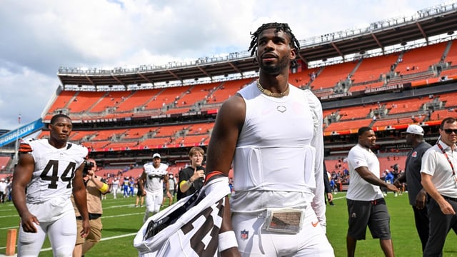 Shedeur Sanders #12 of the Cleveland Browns walks off the field after the team's 17-16 win over the Los Angeles Rams