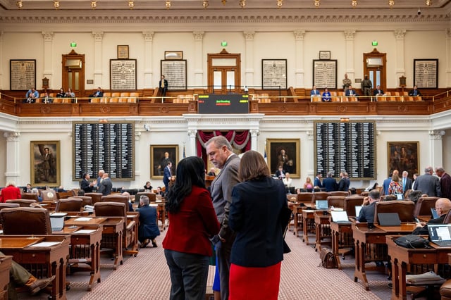 Lawmakers wait in line to debate a redistricting bill in the Texas House on August 20 in Austin.