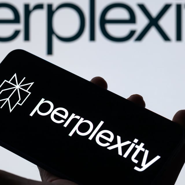 The Perplexity logo is displayed on a mobile phone with Perplexity seen in the background.