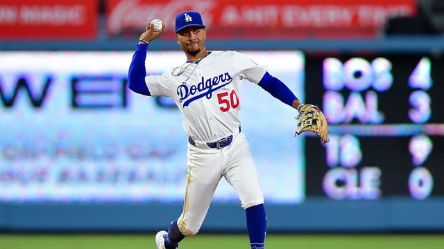 Aug 25, 2025; Los Angeles, California, USA; Los Angeles Dodgers shortstop Mookie Betts (50) throws to first for the out against Cincinnati Reds shortstop Elly De La Cruz (44) during the ninth inning at Dodger Stadium. Mandatory Credit: Gary A. Vasquez-Imagn Images